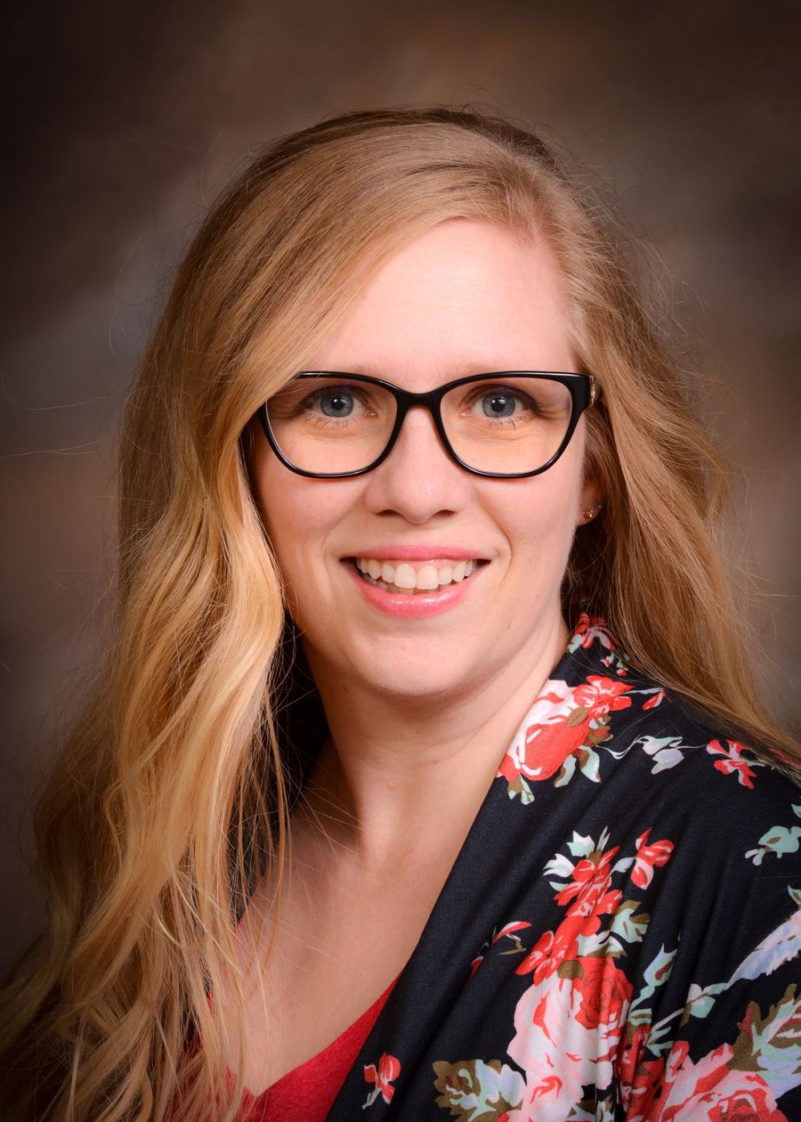 Brandi Felderhoff smiling, in glasses and a floral wrap